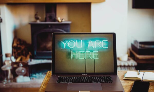 Laptop leży na stole. Wyświetla się napis "You Are Here"